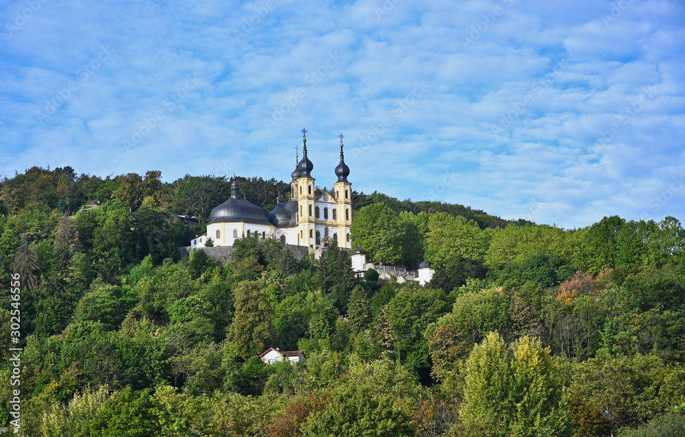 Hillside Church with Onion Dome Bell Towers among Forest