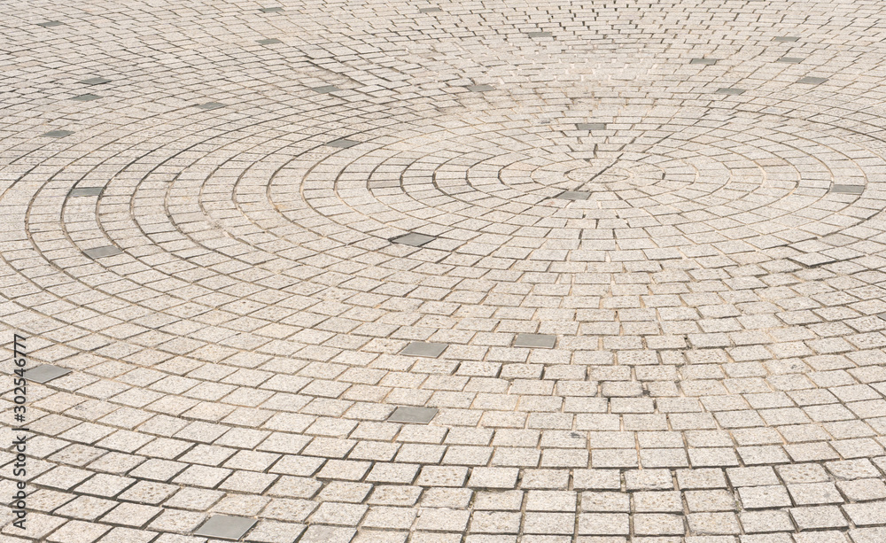 Circle stone tile floor design for footpath in center of urban park, street city exterior background