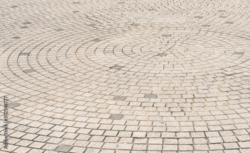 Circle stone tile floor design for footpath in center of urban park, street city exterior background