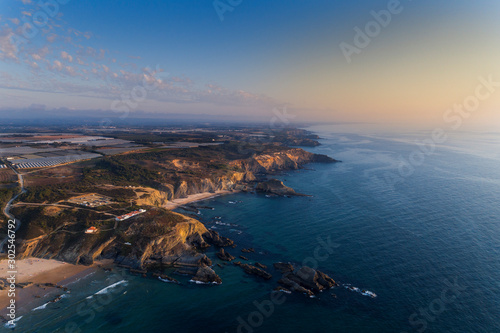 Aerial view of the beautiful Alteirinhos Beach at Zambujeira do Mar, Alentejo, at sunset photo