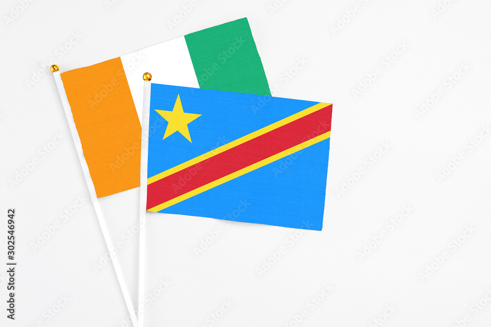 Congo and Cote D'Ivoire stick flags on white background. High quality fabric, miniature national flag. Peaceful global concept.White floor for copy space.