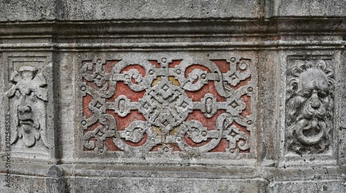 Intricate Carved Stone Fountain Decoration Detail with Painted Background in Wurzburg Germany