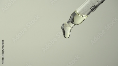 Pipette droplet dosing licensed cannabis CBD oil for medical purposes. Hydroponic biological and ecological hemp plant and herbal pharmaceutical clinic study concept.