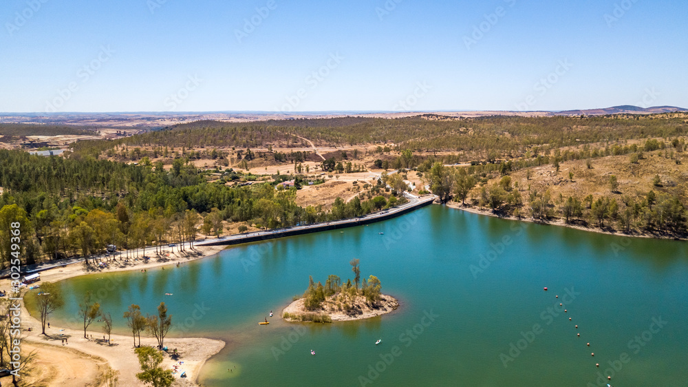 Amazing lake with cristal water surrounded by trees. Mina de S. Domingos, Mertola Alentejo Portugal. drone photo.