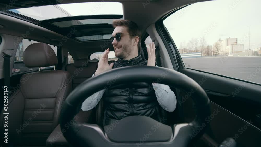 Car driving on autopilot while a man sits inside. Car driving on autopilot while a man sits inside.