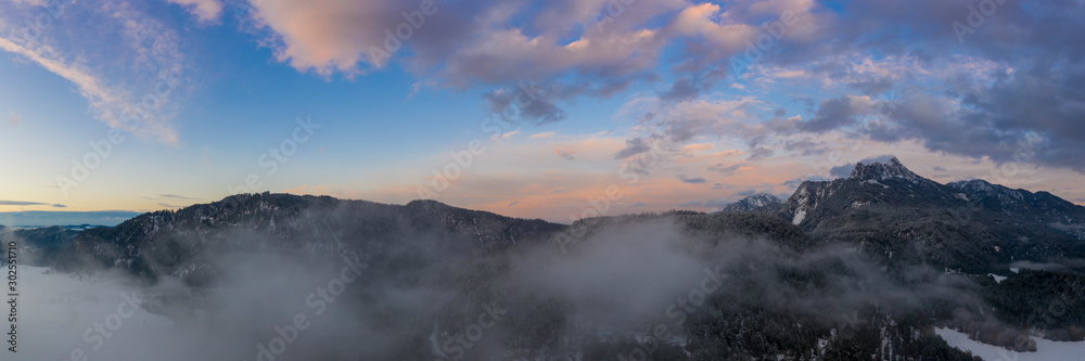 colorful sunset sky panorama with clouds and mountains at austria pinswang