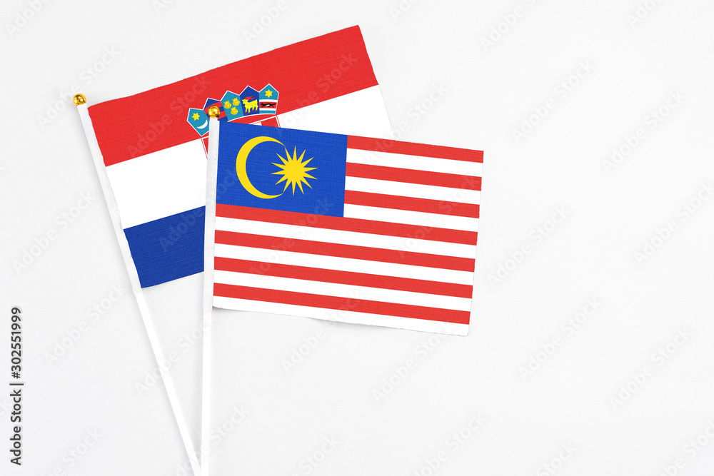 Malaysia and Croatia stick flags on white background. High quality fabric, miniature national flag. Peaceful global concept.White floor for copy space. Malaysia and Croatia stick flags on white background. High quality fabric, miniature national flag. Peaceful global concept.White floor for copy space.