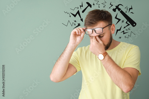 Stressed young man on color...