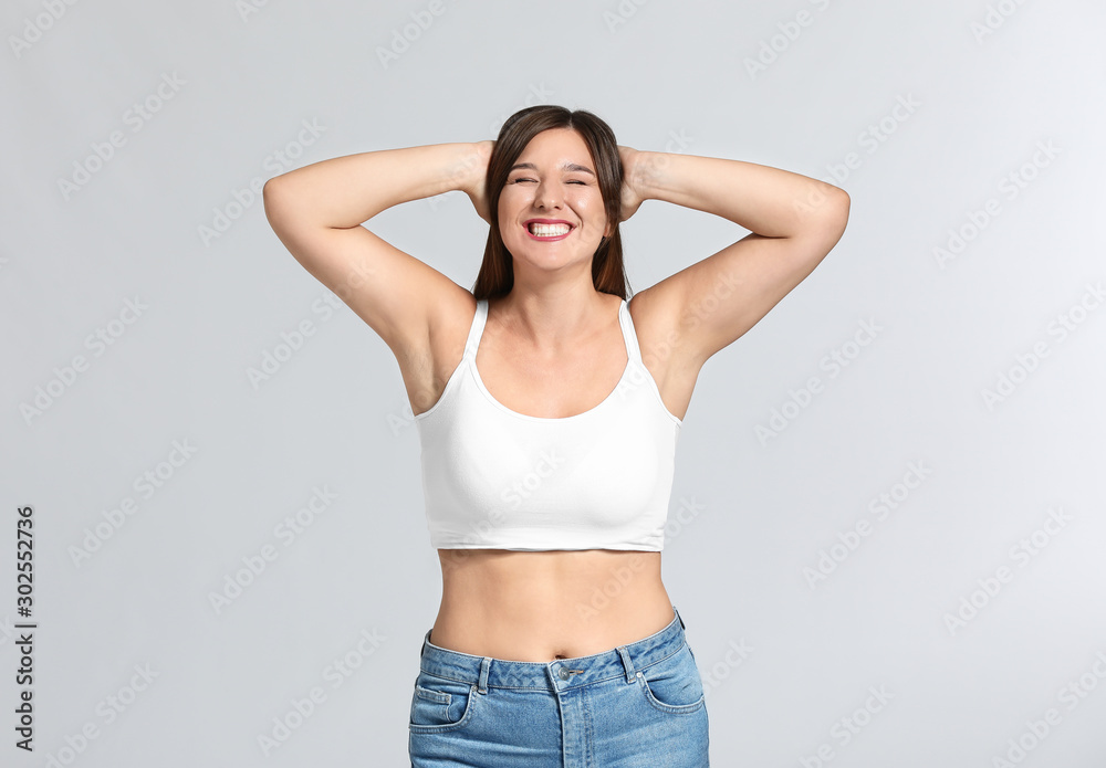 © Pixel-Shot - Young body positive woman on grey background © Pixel-Shot - Young body positive woman on grey background
