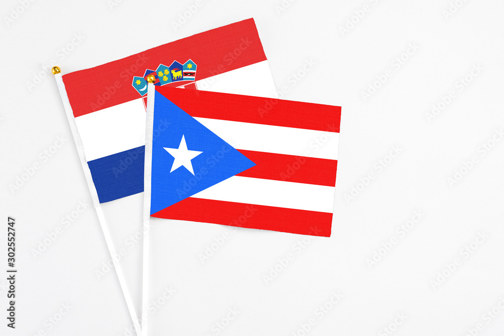 Puerto Rico and Croatia stick flags on white background. High quality fabric, miniature national flag. Peaceful global concept.White floor for copy space. Puerto Rico and Croatia stick flags on white background. High quality fabric, miniature national flag. Peaceful global concept.White floor for copy space.