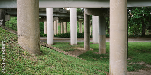 Grassy area and road underneath highway overpass