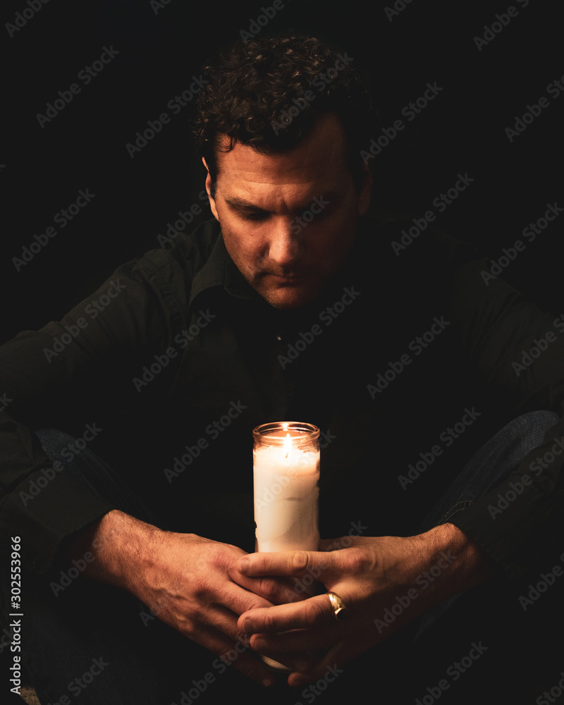 Attractive Male Model Studio Portraits with Candle and praying Attractive Male Model Studio Portraits with Candle and praying