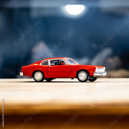 red model car on wood table