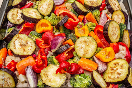 Assorted fresh vegetables on a baking sheet. Healthy food lifestyle. Salt, oil, spices