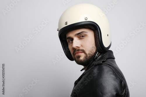 Close-up portrait of biker with white helmet and space for your text. Isolated.