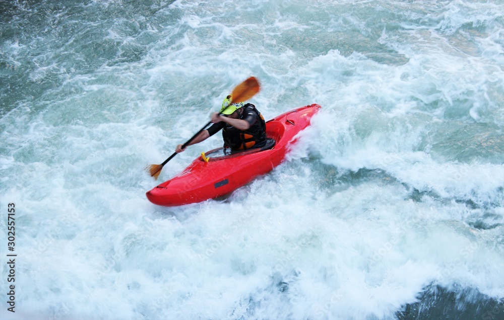 Man sailing in a kayak on a whitewater mountain river