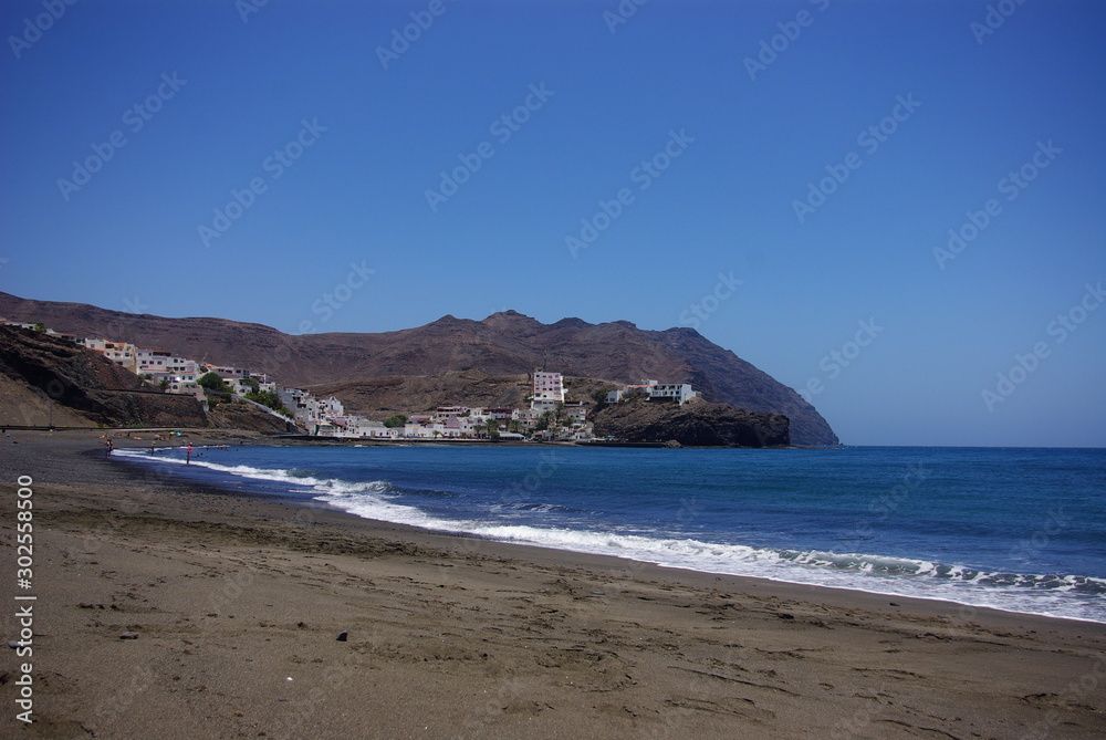 Spectacular sunny day at the beach and the town of Las Playitas with its traditional houses in the mountains Spectacular sunny day at the beach and the town of Las Playitas with its traditional houses in the mountains