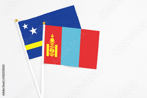 Mongolia and Curacao stick flags on white background. High quality fabric, miniature national flag. Peaceful global concept.White floor for copy space. photo