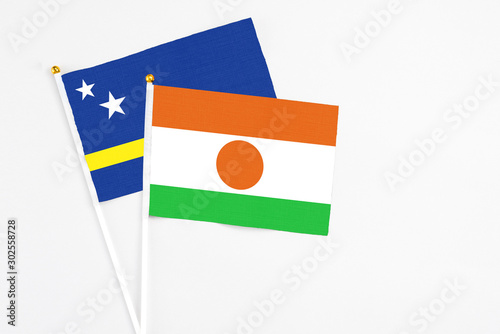 Free Download Niger and Curacao stick flags on white background. High quality fabric, miniature national flag. Peaceful global concept.White floor for copy space. - GFXLoad