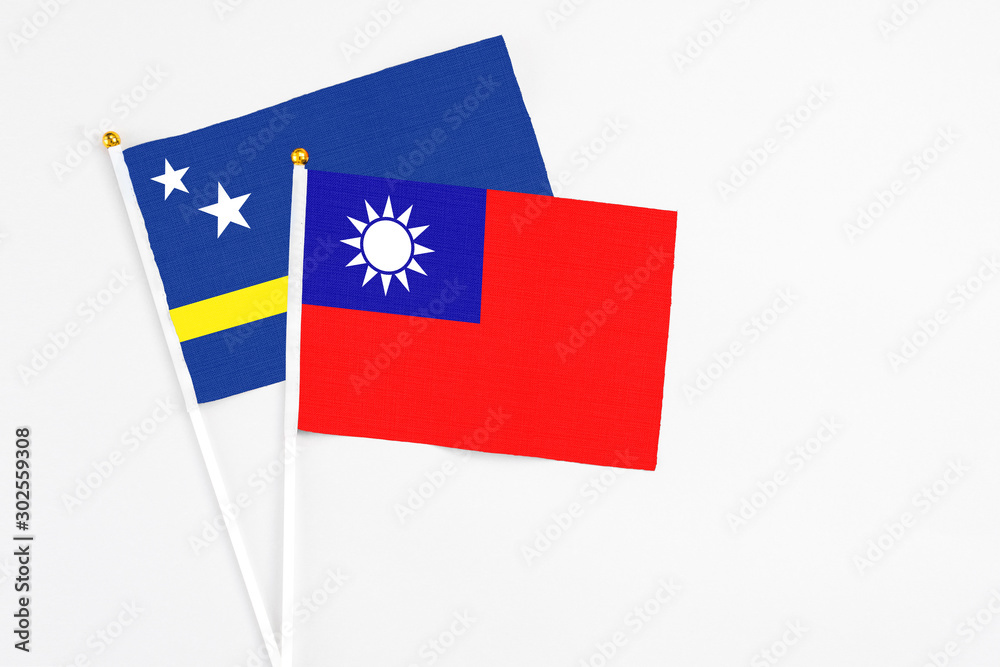 Taiwan and Curacao stick flags on white background. High quality fabric, miniature national flag. Peaceful global concept.White floor for copy space. Taiwan and Curacao stick flags on white background. High quality fabric, miniature national flag. Peaceful global concept.White floor for copy space.