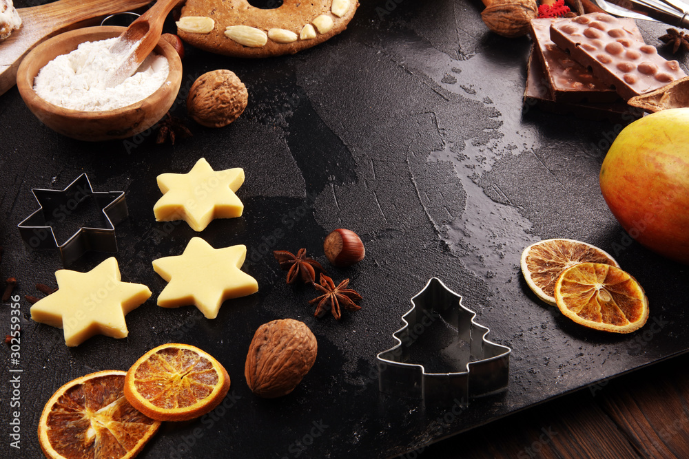 Baking christmas cookies. Typical cinnamon stars bakery with spices. xmas decoration on table Baking christmas cookies. Typical cinnamon stars bakery with spices. xmas decoration on table