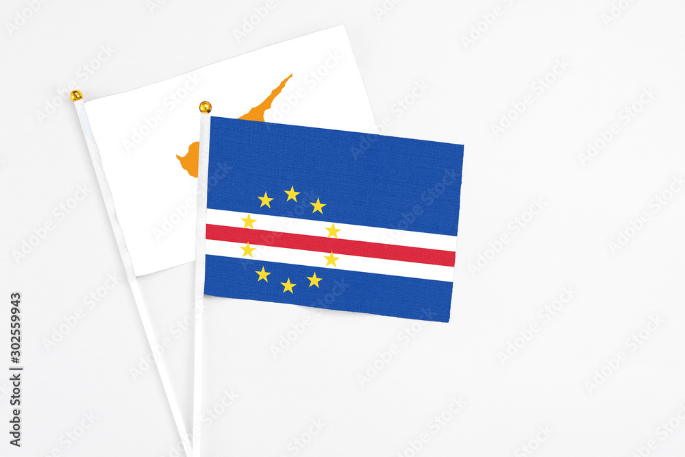 Cape Verde and Cyprus stick flags on white background. High quality fabric, miniature national flag. Peaceful global concept.White floor for copy space. Cape Verde and Cyprus stick flags on white background. High quality fabric, miniature national flag. Peaceful global concept.White floor for copy space.