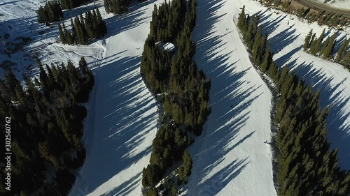 Aerial drone footage of people skiing down hill at Arapahoe Basin in Summit County, Colorado photo