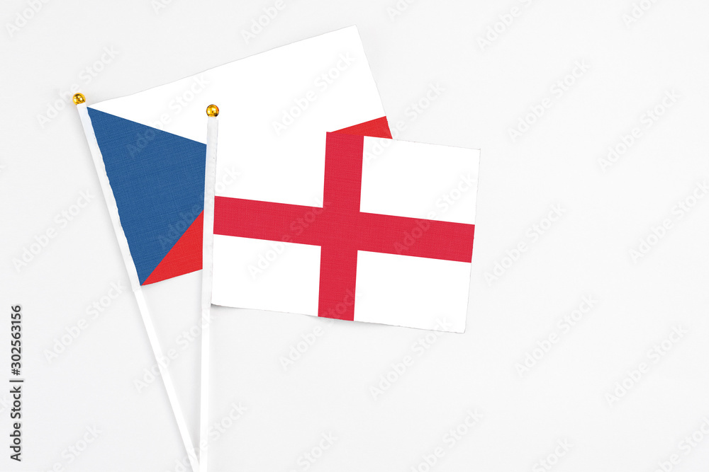 England and Cyprus stick flags on white background. High quality fabric, miniature national flag. Peaceful global concept.White floor for copy space.