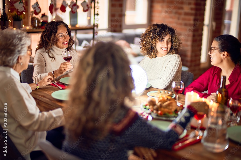 Beautiful group of women smiling happy and confident. Eating roasted turkey celebrating christmas at home Beautiful group of women smiling happy and confident. Eating roasted turkey celebrating christmas at home