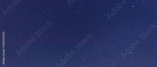 Panorama blue night sky milky way and star on dark background.Universe filled with stars, nebula and galaxy with noise and grain.Photo by long exposure and select white balance.selection focus.amazing