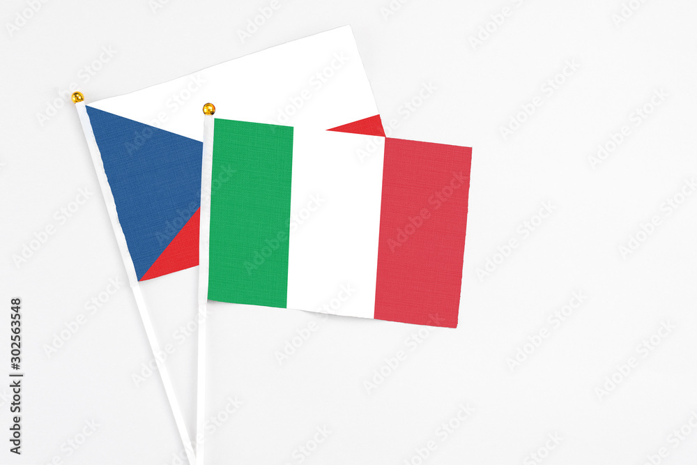 Italy and Cyprus stick flags on white background. High quality fabric, miniature national flag. Peaceful global concept.White floor for copy space.