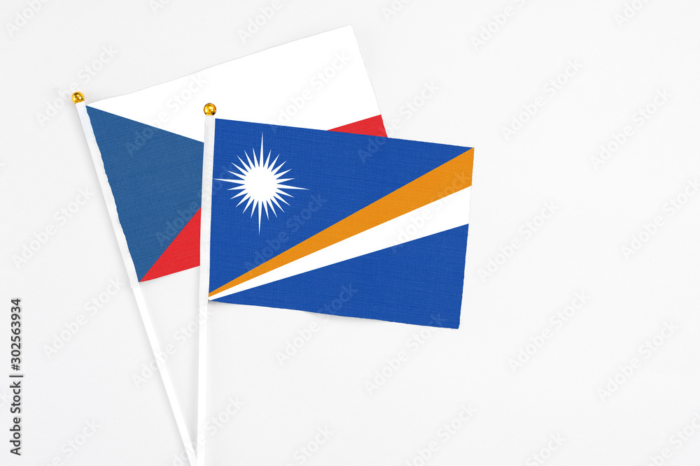 Marshall Islands and Cyprus stick flags on white background. High quality fabric, miniature national flag. Peaceful global concept.White floor for copy space. Marshall Islands and Cyprus stick flags on white background. High quality fabric, miniature national flag. Peaceful global concept.White floor for copy space.