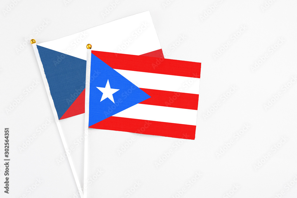 Puerto Rico and Cyprus stick flags on white background. High quality fabric, miniature national flag. Peaceful global concept.White floor for copy space.