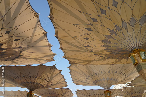 Big umbrella structure of al masjid al nabawi from the holy land and beautiful building structure madinah saudi arabia photo