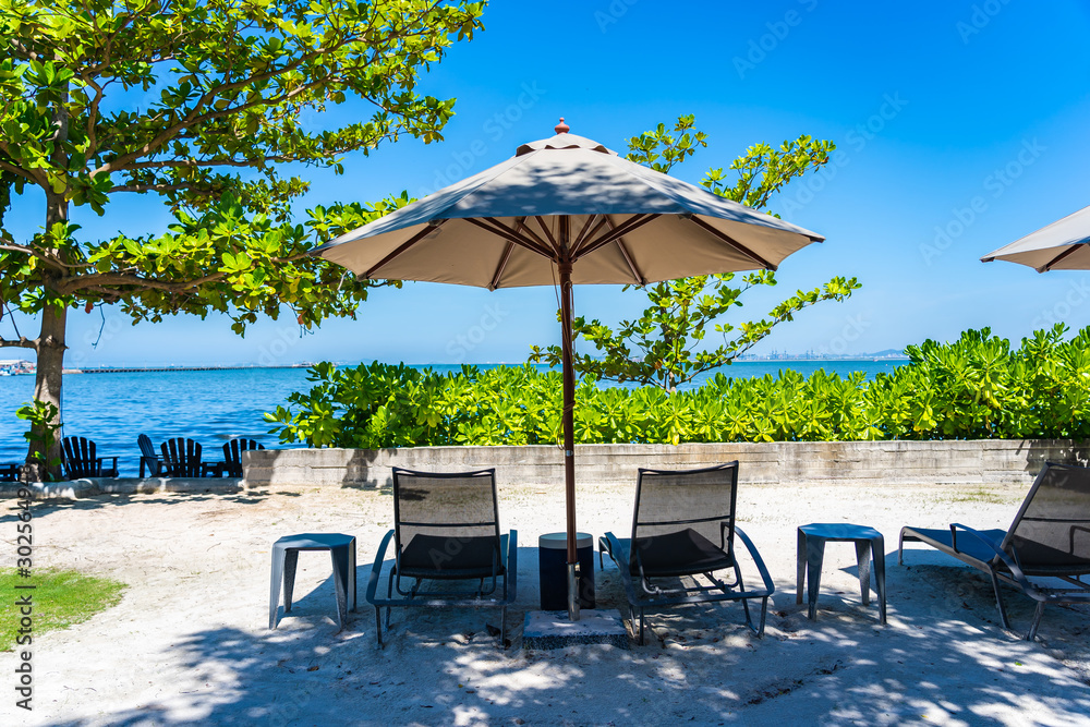 Umbrella and chair on the beach and sea with blue sky