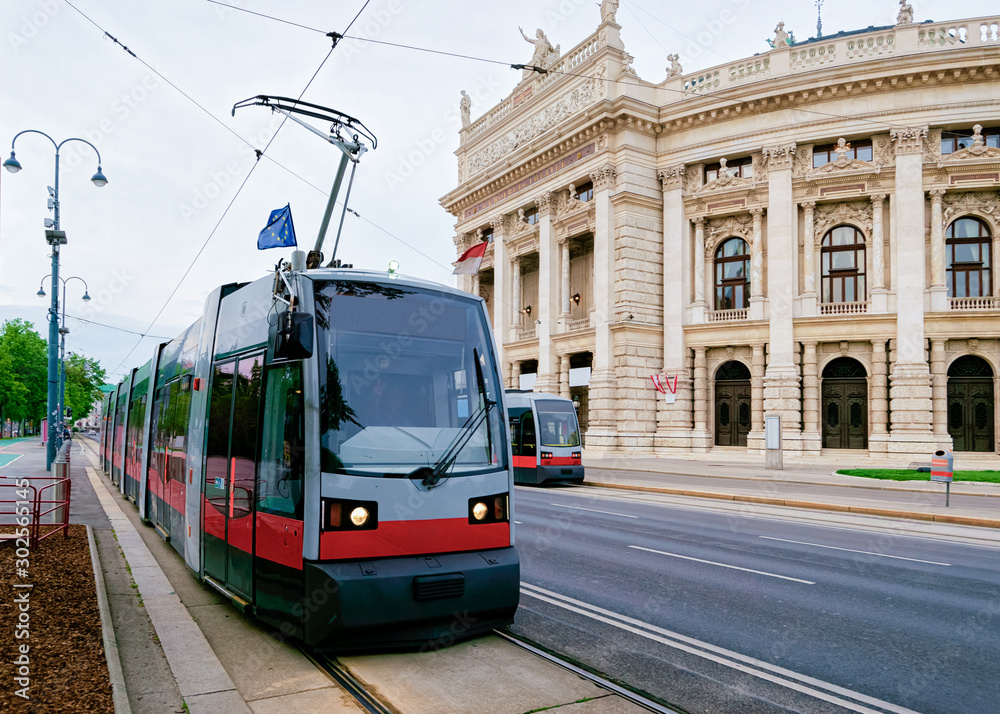 Street view with public tram at Burgtheater in Hofburg Complex, Old city center in Vienna, Austria. Innere Stadt in Wien in Europe. Cityscape. Theater building landmark. Theatre architecture.