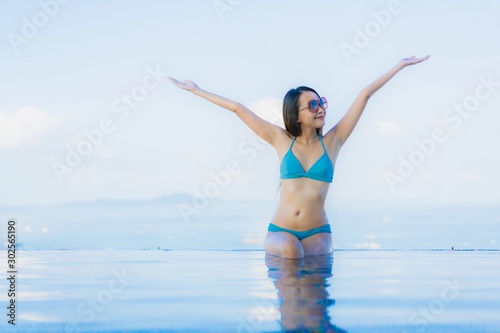 Portrait beautiful young asian women happy smile relax outdoor swimming pool in resort © siraphol