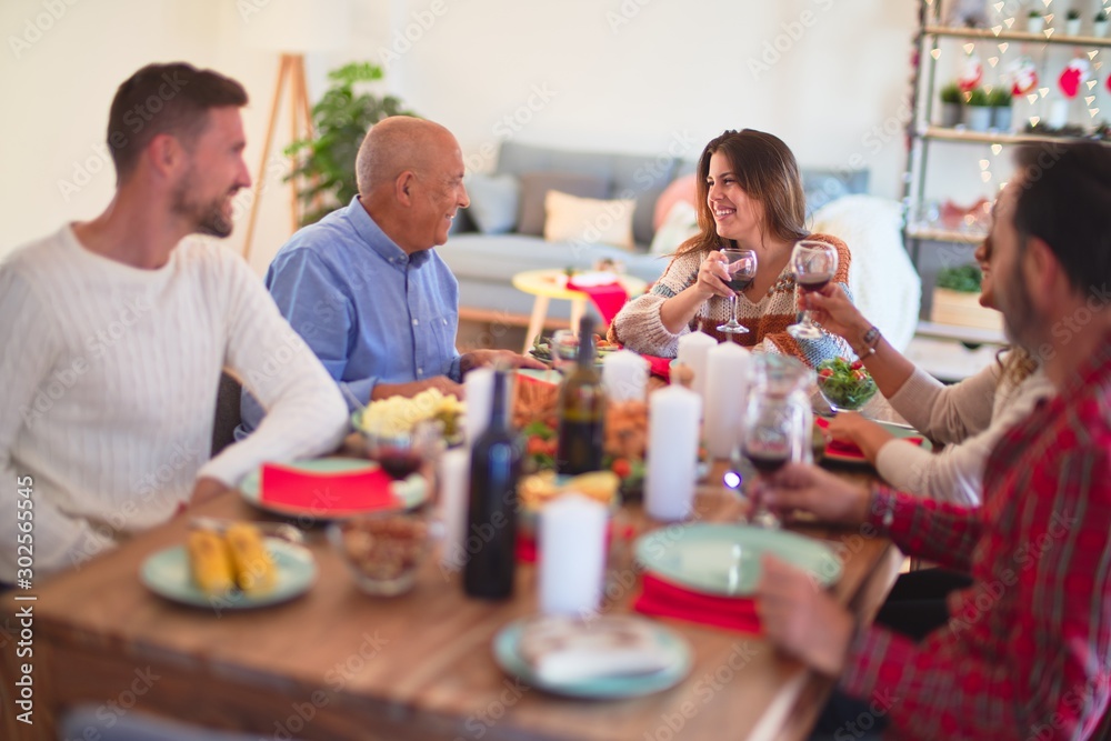 Beautiful family smiling happy and confident. Eating roasted turkey celebrating Christmas at home Beautiful family smiling happy and confident. Eating roasted turkey celebrating Christmas at home