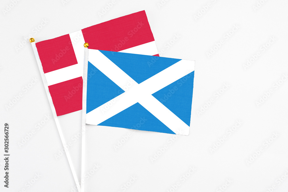 Scotland and Denmark stick flags on white background. High quality fabric, miniature national flag. Peaceful global concept.White floor for copy space. Scotland and Denmark stick flags on white background. High quality fabric, miniature national flag. Peaceful global concept.White floor for copy space.