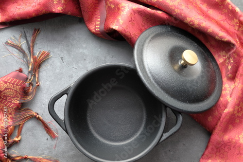 Empty cast iron mini pot with napkin and copy space. photo