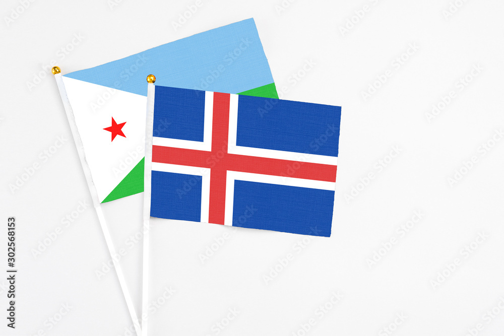Iceland and Djibouti stick flags on white background. High quality fabric, miniature national flag. Peaceful global concept.White floor for copy space.