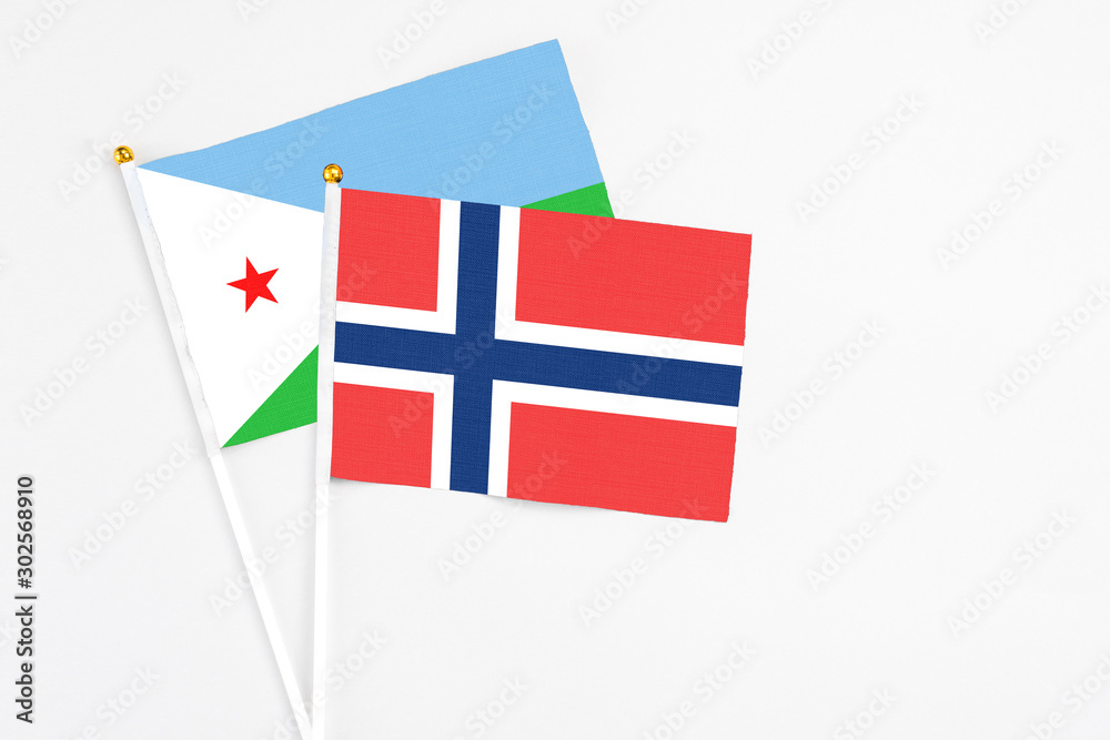 Norway and Djibouti stick flags on white background. High quality fabric, miniature national flag. Peaceful global concept.White floor for copy space.