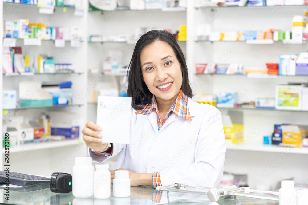 Pharmacist working in pharmacy shop or chemist shop with medication drugstore.