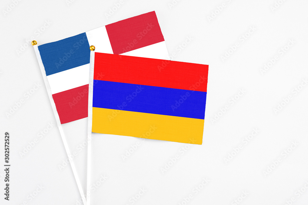 Armenia and Dominican Republic stick flags on white background. High quality fabric, miniature national flag. Peaceful global concept.White floor for copy space. Armenia and Dominican Republic stick flags on white background. High quality fabric, miniature national flag. Peaceful global concept.White floor for copy space.