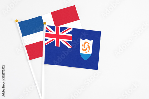 Anguilla and Dominican Republic stick flags on white background. High quality fabric, miniature national flag. Peaceful global concept.White floor for copy space.