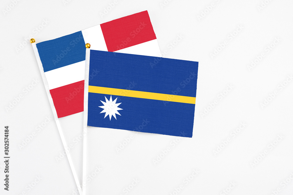 Nauru and Dominican Republic stick flags on white background. High quality fabric, miniature national flag. Peaceful global concept.White floor for copy space. Nauru and Dominican Republic stick flags on white background. High quality fabric, miniature national flag. Peaceful global concept.White floor for copy space.