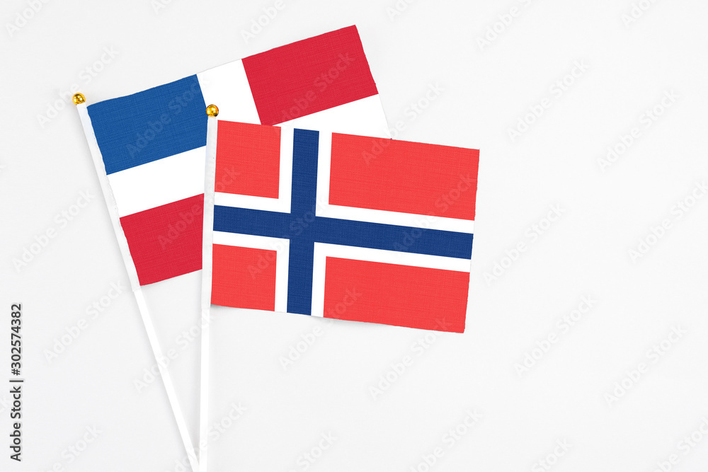 Norway and Dominican Republic stick flags on white background. High quality fabric, miniature national flag. Peaceful global concept.White floor for copy space. Norway and Dominican Republic stick flags on white background. High quality fabric, miniature national flag. Peaceful global concept.White floor for copy space.