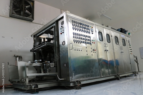 Vacuum thermoforming machine in the factory,Vacuum thermoforming machine is used for producing plastic packaging,Vacuum thermoforming machine in factory room
