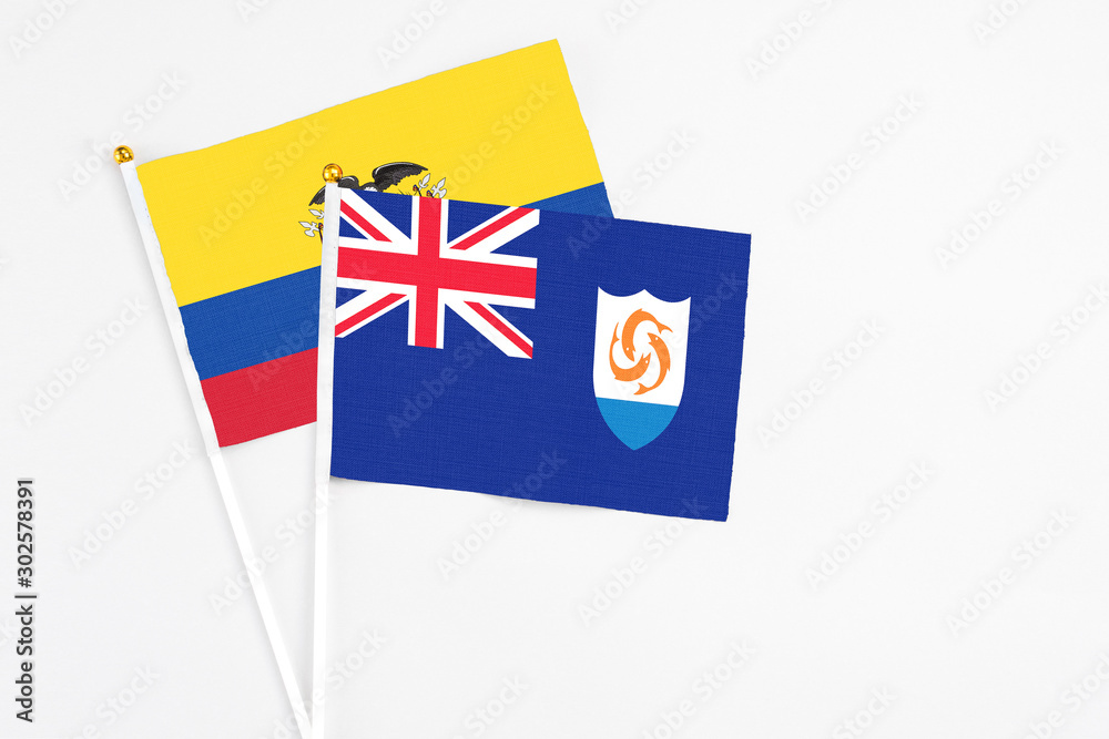 Fototapeta premium Anguilla and Ecuador stick flags on white background. High quality fabric, miniature national flag. Peaceful global concept.White floor for copy space.