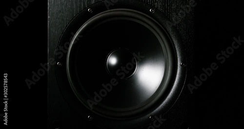 CLOSE UP moving sub-woofer music speakers vibrating membrane white strobe pulsing light photo